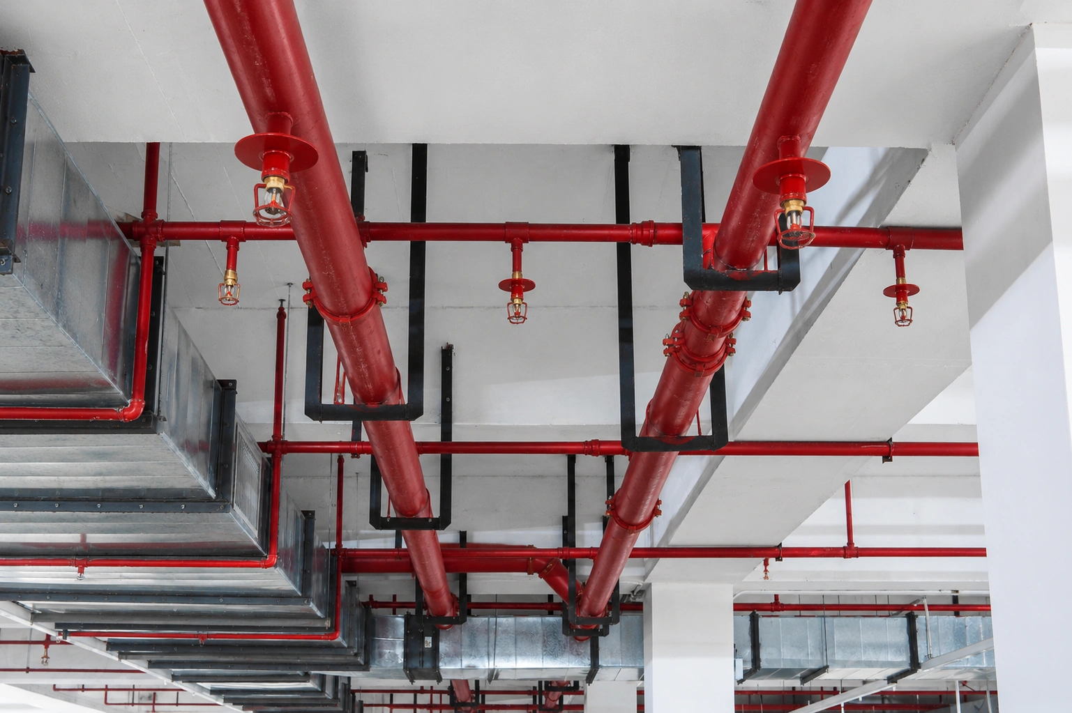 Technician inspecting a warehouse fire sprinkler system