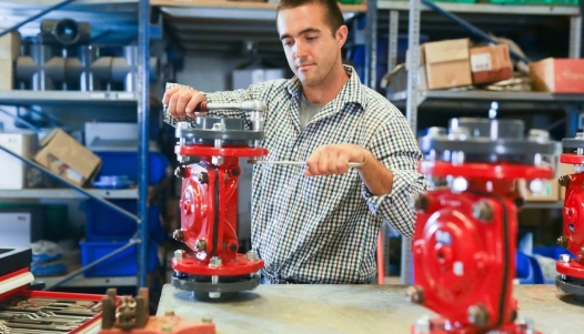 Technician inspecting an industrial fire sprinkler system